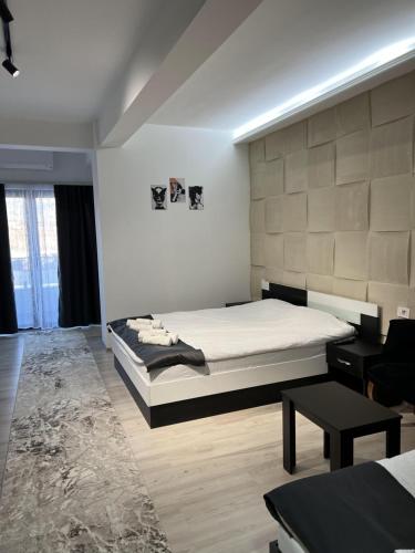 a bedroom with a king sized bed and a table at Hotel FOCUS in Prilep