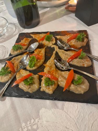 a tray of food on a table with spoons at Cosy Guest House Sous le Badamier in Grand Baie