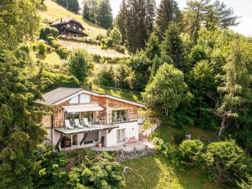 an aerial view of a house in a forest at Chalet Chalet Coin de Paradis by Interhome in Caux sur Montreux