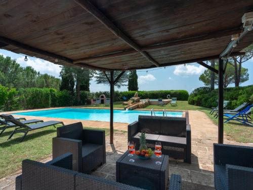 a patio with chairs and a swimming pool at Villa La Veduta by Interhome in Grosseto