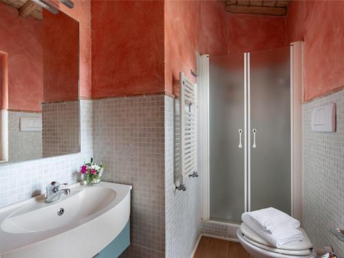 a bathroom with a toilet and a sink and a shower at Villa La Veduta by Interhome in Grosseto