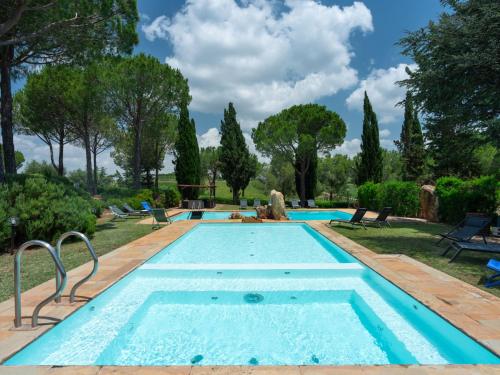 a swimming pool in a yard with trees at Villa La Veduta by Interhome in Grosseto