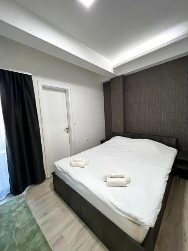 a bedroom with a bed with two towels on it at Hotel FOCUS in Prilep