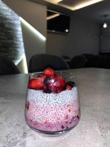 a glass jar with strawberries and blueberries in it on a table at Hotel FOCUS in Prilep