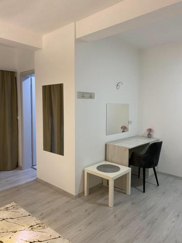 a white room with a desk and a table at Hotel FOCUS in Prilep