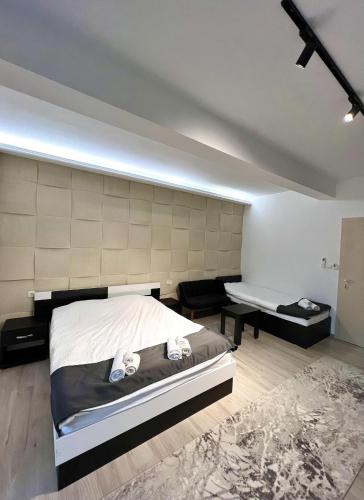 a bedroom with a bed and a bench in it at Hotel FOCUS in Prilep