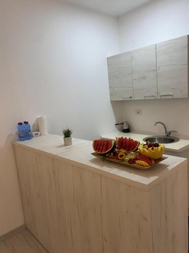 a kitchen with a counter with fruit on it at Hotel FOCUS in Prilep