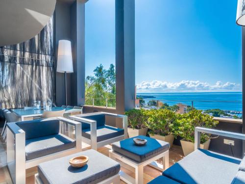 Habitación con sillas, mesas y vistas al océano. en Villa Vistamar by Interhome, en Palma de Mallorca