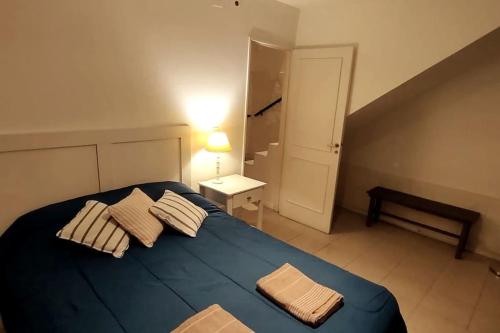 ein Schlafzimmer mit einem blauen Bett mit zwei Kissen darauf in der Unterkunft Departamento con estilo en Barrio Bombal in Godoy Cruz