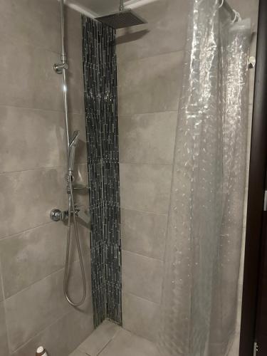 a shower with a shower curtain in a bathroom at Greek Escape in Paleo Tsifliki