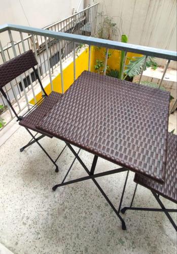 a table and two chairs sitting on a balcony at Ulysses Apartments Acropolis in Athens