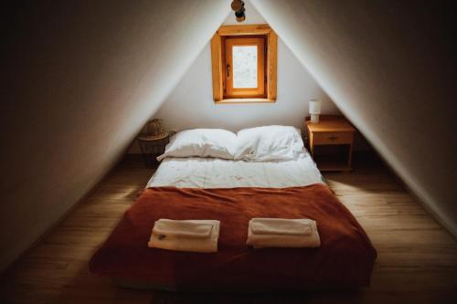a bedroom with a bed with two towels on it at Jasminowe Wzgorze in Wilkanów