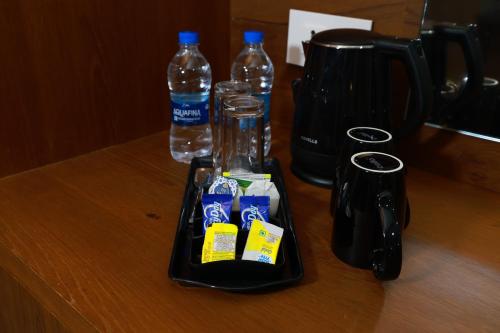 a tray with bottled water and two bottles on a table at KKM INTERNATIONAL in Trivandrum