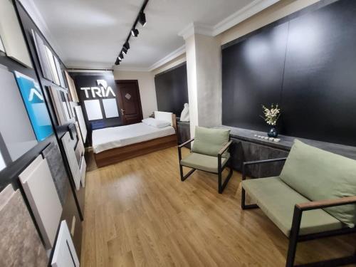 a living room with a couch and a bed at tria house in Antalya