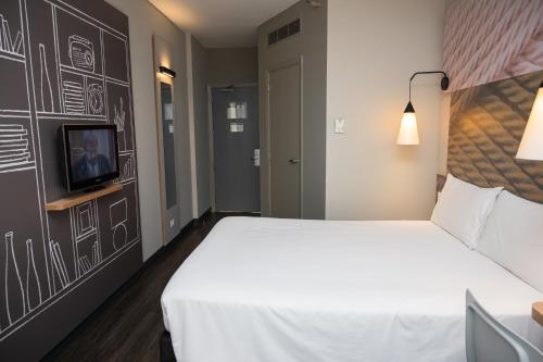 Ένα ή περισσότερα κρεβάτια σε δωμάτιο στο ibis Ribeirao Preto Shopping