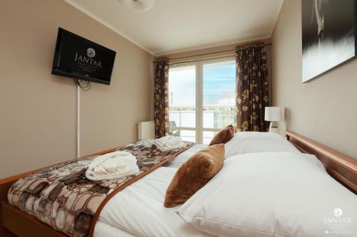 Postel nebo postele na pokoji v ubytování Jantar Apartamenty - AQUARIUS Apartamenty