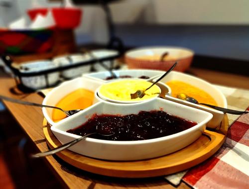 a bowl of jam on a plate on a table at Scala 68 in Bogotá