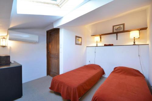 a bedroom with two beds and a skylight at Terrasses du château in Le Barroux