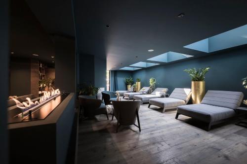 a waiting room with couches and chairs in a building at Post Hotel - Tradition & Lifestyle Adults Only in San Candido