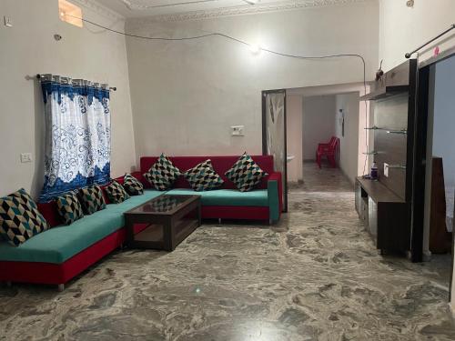 a living room with a couch and a table at Parmarth Lok in Deoghar