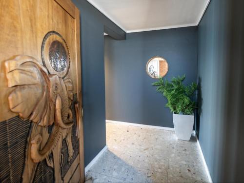 a hallway with a wooden door and a potted plant at GND Properties Luxury Apartment in Summerstrand