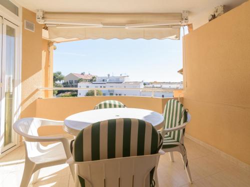 a balcony with a table and chairs and a window at Apartment Villas del Mar by Interhome in Jávea