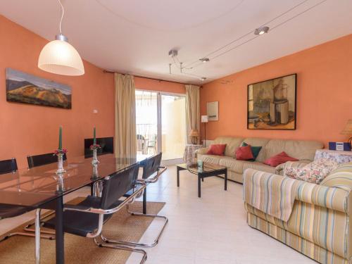 a living room with a table and a couch at Apartment Villas del Mar by Interhome in Jávea