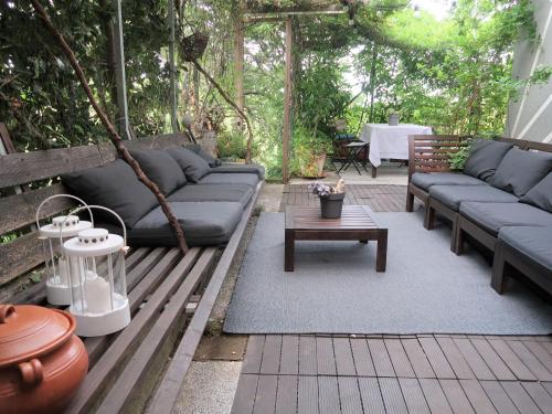 a patio with a couch and a coffee table at Apartment Branka by Interhome in Mošćenička Draga