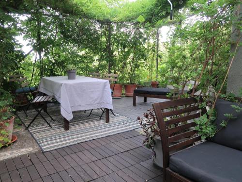 a table and chairs on a patio with trees at Apartment Branka by Interhome in Mošćenička Draga