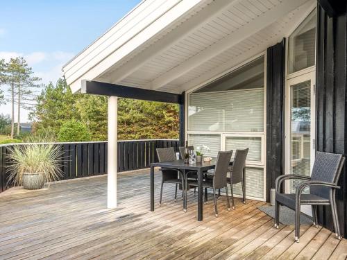 a patio with a table and chairs on a deck at Holiday Home Alvy - 200m from the sea in Djursland and Mols by Interhome in Ebeltoft
