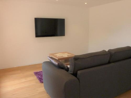 a living room with a couch and a table at Apartment Wiedersehn 1- Stock by Interhome in Grächen
