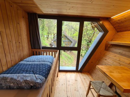 a bedroom with a bed in a wooden cabin at Chalet Bosco della Bella 6 by Interhome in Termine