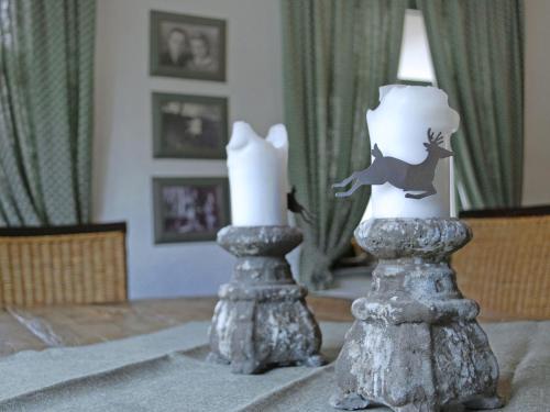 two candles sitting on top of a table at Apartment Vilm by Interhome in Dargun