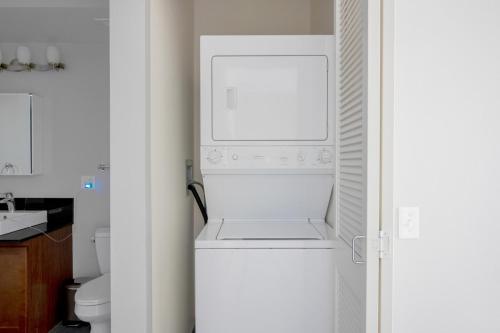 a white washer and dryer in a kitchen at Loop 1BR w gym pool lounge 1 block from L CHI-699 in Chicago