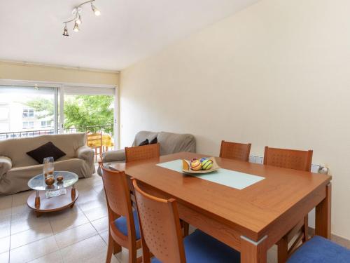 a dining room with a wooden table and chairs at Apartment Puig Sapera by Interhome in Sant Antoni de Calonge
