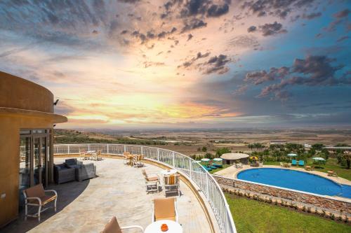 a view from the balcony of a resort with a pool at Bhalil Farm House in Sefrou