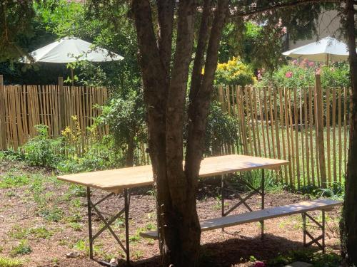 a picnic table and a bench next to a tree at Apartment L'Avenir-2 by Interhome in Presinge