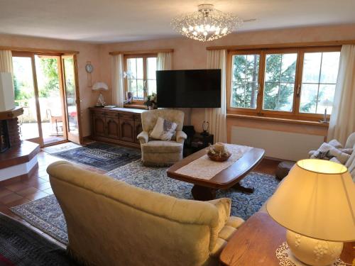 a living room with a couch and a table at Holiday Home Chalet Bergnest by Interhome in Pragg-Jenaz