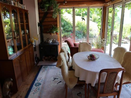 a dining room with a white table and chairs at Holiday Home Chalet Bergnest by Interhome in Pragg-Jenaz