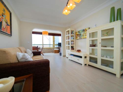a living room with a couch and some shelves at Apartment Etxezuri by Interhome in Calpe