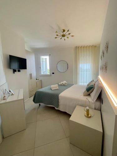 a bedroom with a bed and a ceiling at Milena Suite Apartments in Alghero