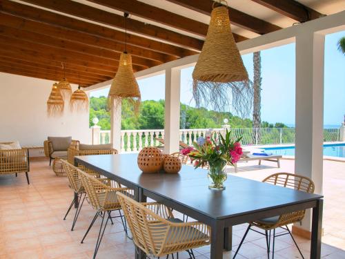 a dining room with a table and chairs at Villa Pax et Lucis by Interhome in Benissa