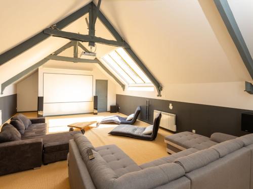 - un salon avec des canapés et une grande fenêtre dans l'établissement Holiday Home La Gentilhommière by Interhome, au Tronchet