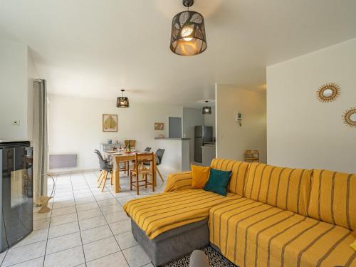 a living room with a couch and a table at Holiday Home Villa Margarin by Interhome in Les Mathes