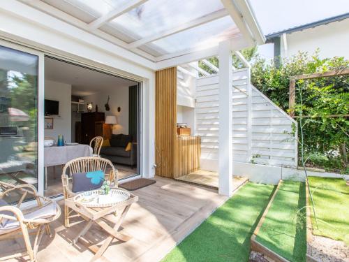 une terrasse ouverte avec une table et des chaises sur une pelouse dans l'établissement Studio Biarritz by Interhome, à Capbreton