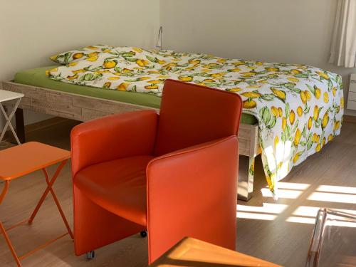 a bedroom with a bed and a chair and a bed at B&B tannen124 in Oberburg