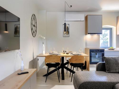 a kitchen and living room with a table and chairs at Holiday Home Villa Luca by Interhome in Tinjan