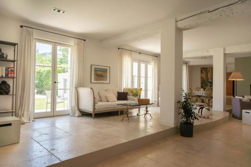 a living room with a couch and a table at Unique Villa in Famous Provence Historic Village in Villeneuve-lès-Avignon
