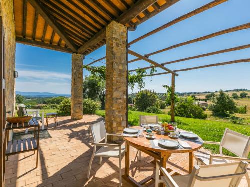 a patio with a table and chairs on a brick patio at Holiday Home Marte by Interhome in Pereta