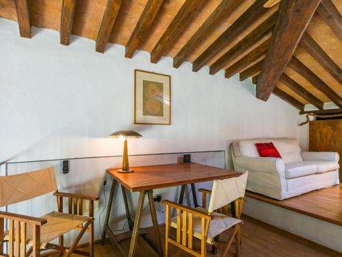a room with a table and chairs and a couch at Holiday Home Marte by Interhome in Pereta